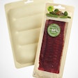 THERMOFORMABLE PAPER-BASED TRAY. Shown here are two of the seven varieties of chilled meat products packaged by Micarna in the PaperLite material.