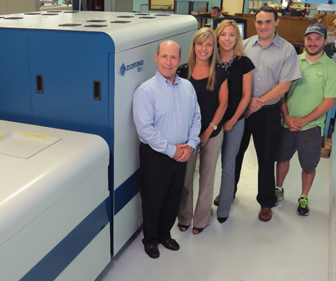 Proud owners at McCourt Label pose beside their new digital label press.