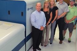 Proud owners at McCourt Label pose beside their new digital label press.