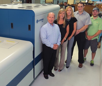 Proud owners at McCourt Label pose beside their new digital label press.