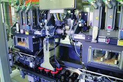 SIX PRE-DOSERS. The customized modular linear filler features a portioning system that begins with six pre-dosers that fill containers approximately 80% of the fill volume using a large auger filler.