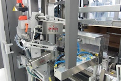 INBOUND CARTONS. As cartons visible in the lower right corner are conveyed into a case packer, a camera reads all 100 unique carton codes; then the system asks for a unique parent label with which all 100 carton codes are associated.
