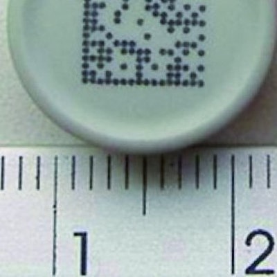 VIAL STOPPER. This image shows a continuous ink-jet code on a vial stopper.