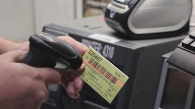 PRINT JOB. A Hypertherm employee initiates a print job through barcode scanning.