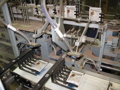 nce pouches are cut into individual units, a pick-and-place device puts each pouch on a pedestal checkweigher.