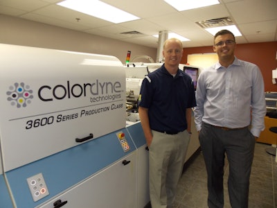 Exacto's Tom Martin (left) stands in from of his firm's new 3600 Series Laser Pro with Colordyne's Taylor Buckthorpe.