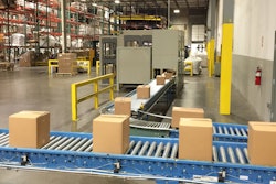 Filled/sealed shipping cases are roller-conveyed to the palletizing station.