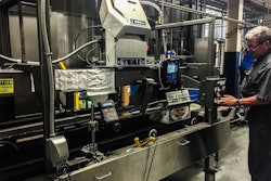 The compact InvisiPac system, shown here on the brewery’s case packer, incorporates an integrated vacuum feed, tank-free glue melter, heated hoses, glue applicators, and process control technology.