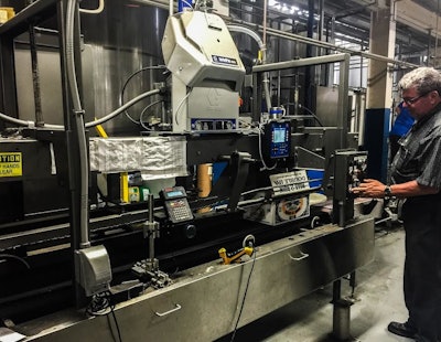 The compact InvisiPac system, shown here on the brewery’s case packer, incorporates an integrated vacuum feed, tank-free glue melter, heated hoses, glue applicators, and process control technology.