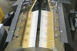 Shown here is one of 12 automated feeding systems. Including both left and right sides, each feeding system deploys 180 rollers in clusters of six. Each cluster has its own sensor, its own stepper motor/drive combo, and its own controller. Because each cluster communicates with the ones around it, each controller knows if the overall goal of singulating the flow of pouches will be better accomplished by speeding up or slowing down its six rollers.
