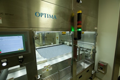 A cart transfers formatted vials from the filling machine and loads them into the freeze dryer through a small “pizza door.”