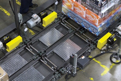 The low-level drag chain conveyor lets Frank Beer load and unload three pallets at a time.