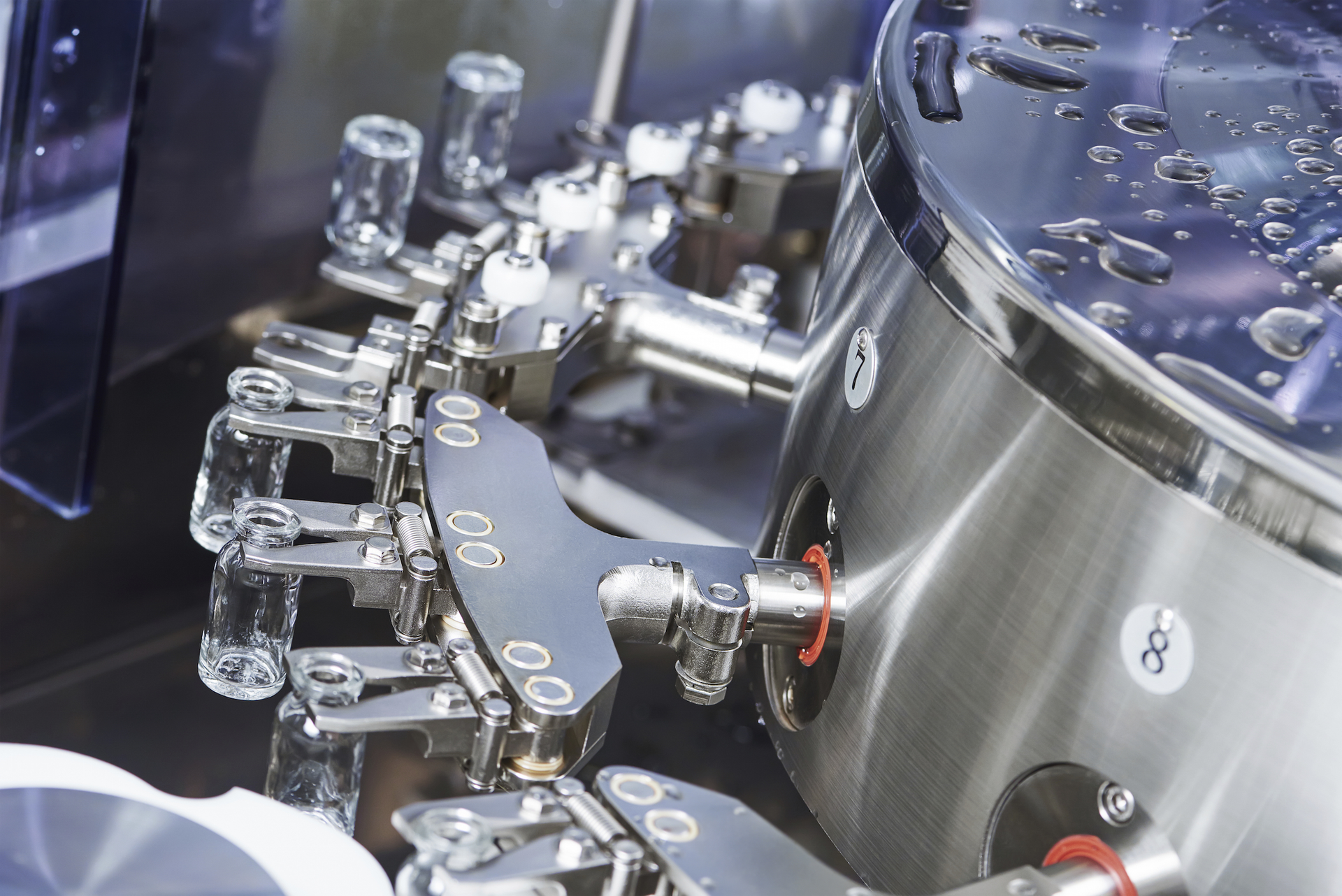 In this photo for illustrative purposes only, a pharmaceutical machine handles glass bottles.