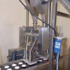 Honeyville uses a dual drop volumetric cup filler with staging gate to fill two containers at a time.
