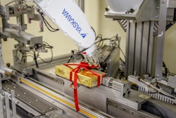 At Esther Price Candies, a six-axis robot with controller ties ribbons around candy boxes and forms bows at 2 boxes/min.