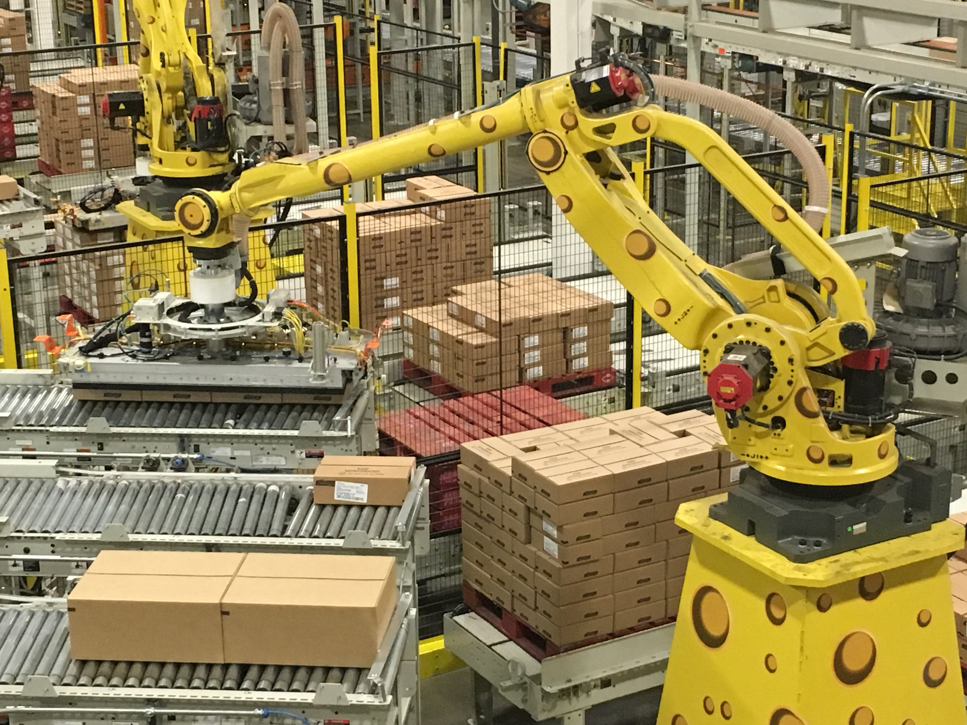 Robots palletizing cases of cheese have been decorated by Sargento with Swiss-hole decals to &lsquo;cheesify&rsquo; them.