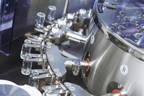 In this photo for illustrative purposes only, a pharmaceutical machine handles glass bottles.