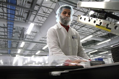 Packaging product within a cleanroom at Millstone Medical Outsourcing.