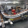Photo A--The fully automated case packing operation—case erector, robotic case loader, and case closer.