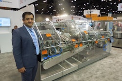 Sabri Demirel, Ulhmann Packaging Systems LP, stands next to refurbished equipment at the Uhlmann booth.
