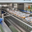 Shown are filled trays entering the SEALPAC A6 tray sealer.