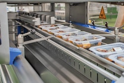 Shown are filled trays entering the SEALPAC A6 tray sealer.