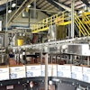 A high-level depalletizer single files and feeds bottles into a lowerator on their way down the line. Many of the equipment suppliers represented in the line are located near the brewery’s Richmond, VA, location.