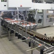 Shortly after freshly filled bottles enter the Varioline packing system, they’re picked and placed into cases that have six-pack paperboard carriers already in them.