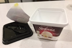 Spoon is held in lid by pressure-sensitive label.