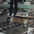 A gantry robot wraps the corrugated around the order.