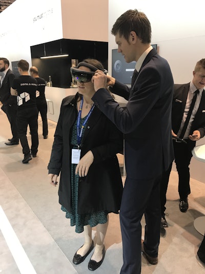 Keren Sookne, Director of Content for Healthcare Packaging, gets fitted for an 'augmented reality' tour in the Pester booth here at Interpack in Düsseldorf.