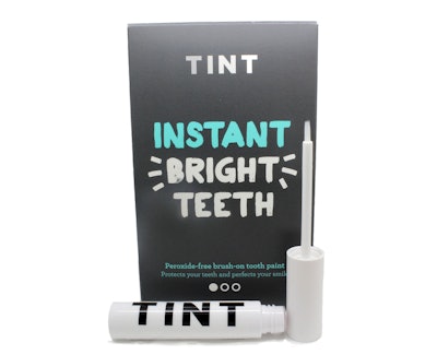 TINT is packaged in a lipgloss-style pack that lets users brush the whitener onto their teeth.