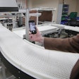 Rob Radwin positions a smartphone to record video of a conveyor belt — a better method for measuring the risk presented by repetitive workplace tasks and safeguard workers against injury. Photo: Stephanie Precourt/UW–Madison