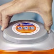 A new lid for the Tide PODS tub requires users to squeeze and twist the lid at the same time for greater child-resistance.
