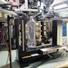 The Process Pilot goalpost sits in the blowmolder takeout area, its sensors measuring bottle thickness at 12.5-mm intervals along the sidewall.