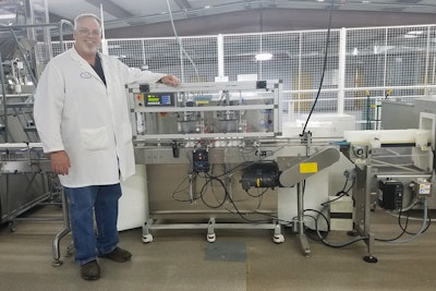 David Burrus, Plant Manager at Lifeplus, stands next to the company’s CS10 cotton inserting machine.
