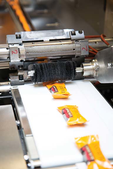 The Cavanna Zero 5 horizontal flow wrapper can wrap up to 700 chocolate-covered toffee pieces per minute versus 220 pieces a minute with Enstrom&rsquo;s previous packaging equipment. Photo courtesy of Enstrom Candies.