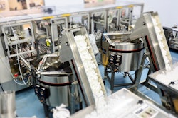 Side-by-side bowl feeders bring the two sub-assemblies into the filling and pressurizing system.