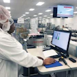 Sovensky Preston (front) and Janice Jackson (rear) analyze OEE data on Packaging Line 2 at Pharmavite in Opelika, Alabama.