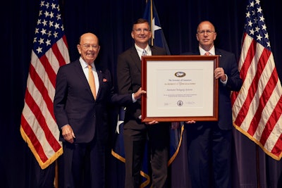 James K. Hawley, Director of International Business Development (right), and Philip Lesniak, Import/Export Manager (center), of Automated Packaging Systems, receive the President’s “E” Award for Exports from Wilbur Ross, Secretary of Commerce (left).