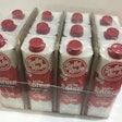 12-pack cases of capped 1-L milk cartons use inserted corrugated in a shrink bundle instead of a corrugated case.