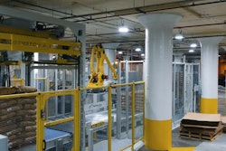A robotic bag palletizer creates perfectly uniform stacks of bags on a pallet, which then receives a stretch hood.