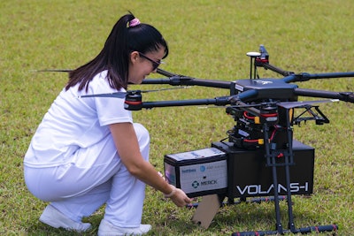 A Merck medication treatment is loaded into a drone for delivery during the “Proof of Concept” project.