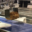 The robotic pick-and-place system with new EOAT loads full, sliced loaves into a thermoformer for MAP packaging.