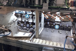 Closure Subassemblies—each in a puck and each already filled with liquid amplifier—enter the Nuspark system and are immediately pushed from a white conveyor belt and into a station where four mechanical grippers (A in photo) orient them four at a time. The pucks are then pushed to the next position (B in photo), where four Casing Subassemblies come down from above and are placed in the four Closure Subassemblies. Then the four pucks are pushed back onto the white conveyor belt, which takes them to the next station.