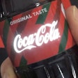 Printed electronics technology causes the Coca-Cola logo to light up at the touch of the hand.
