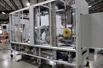 This case sealer was tailor-made for the e-commerce industry in response to the demand for highly flexible equipment. Instead of having uniform sealers at the end of lines, Pearson will install a sealer like this that automatically adjusts to the different case dimensions that are coming at it on the fly. The sealer has many moving parts inside, the first checks the width of the box, the second checking the height, and there are photo eyes up front that will adjust the equipment to handle whatever it sees. Finally, the tape head will automatically adjust to accommodate the different box sizes. The first moving part checks the width of the box. And then this will check the height of the box.