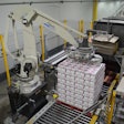 The robot picks two rows of six 4-lb bags from a conveyor and transfers them to the display.