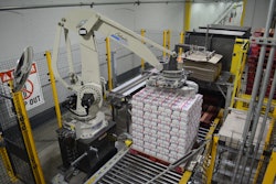 The robot picks two rows of six 4-lb bags from a conveyor and transfers them to the display.