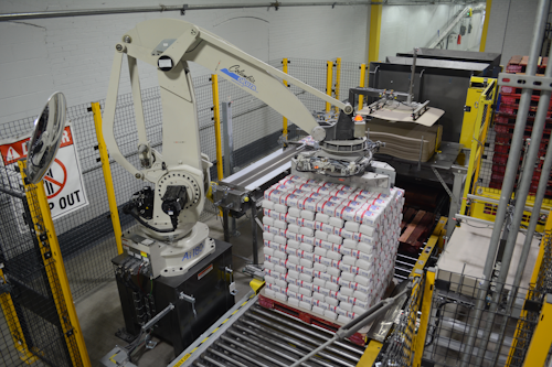 The robot picks two rows of six 4-lb bags from a conveyor and transfers them to the display.
